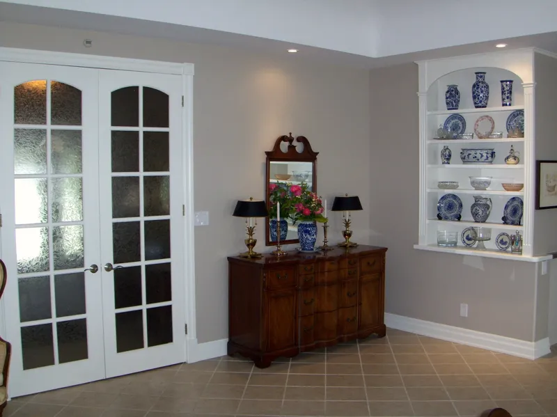 Living room with French doors and built-in cabinets